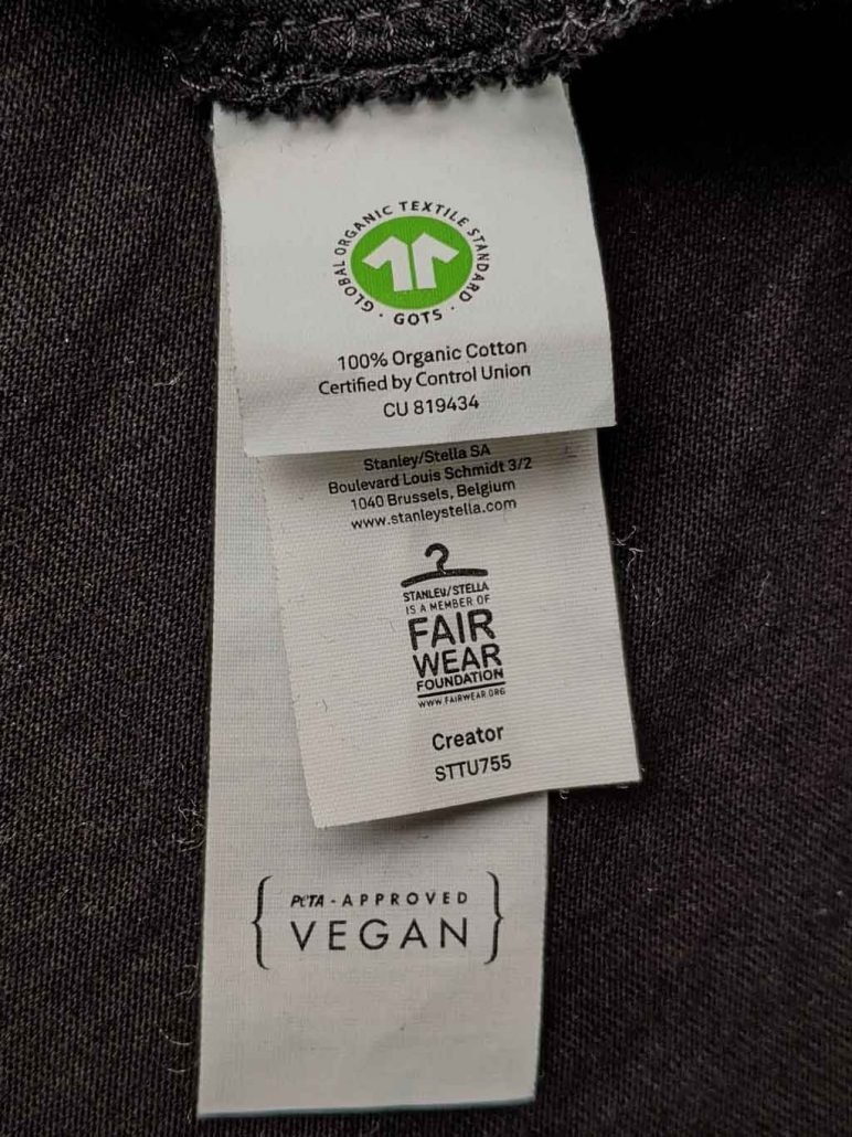 GOTS, FWF and PETA label attached to a fair organic vegan T-Shirt at GuterStoff.com textile merchandising Vienna Austria